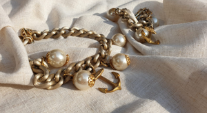 Gold chain necklace and bracelet with pearl and anchor detail